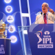 Image of IPL auction anchor and IPL trophy on display