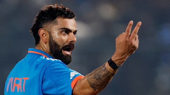 Virat Kohli gives a hand gesture on the field during a match